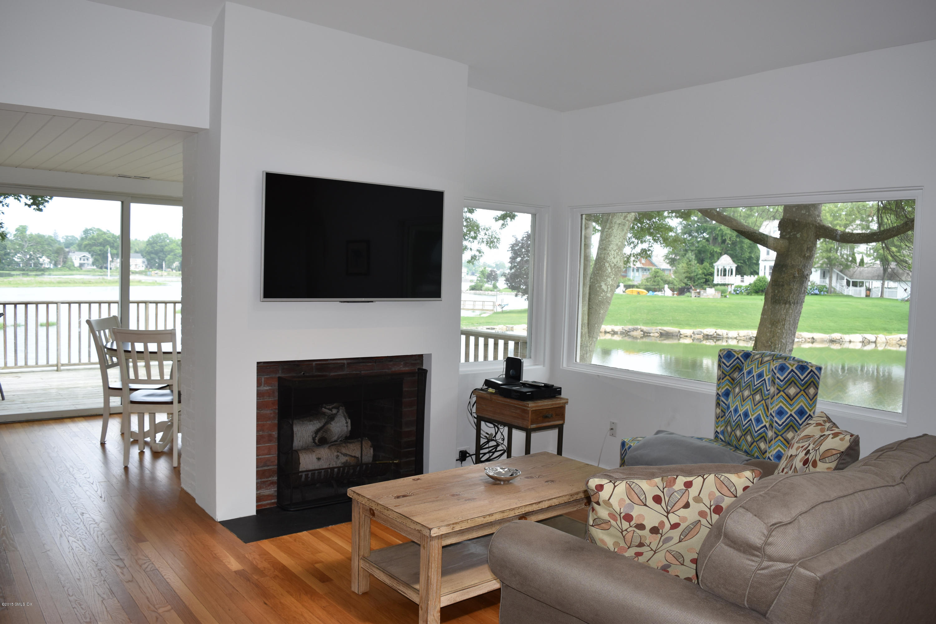 25 Willowmere Avenue Riverside, CT 06878 - Photo 4 of 12 a living room with furniture a fireplace and a flat screen tv