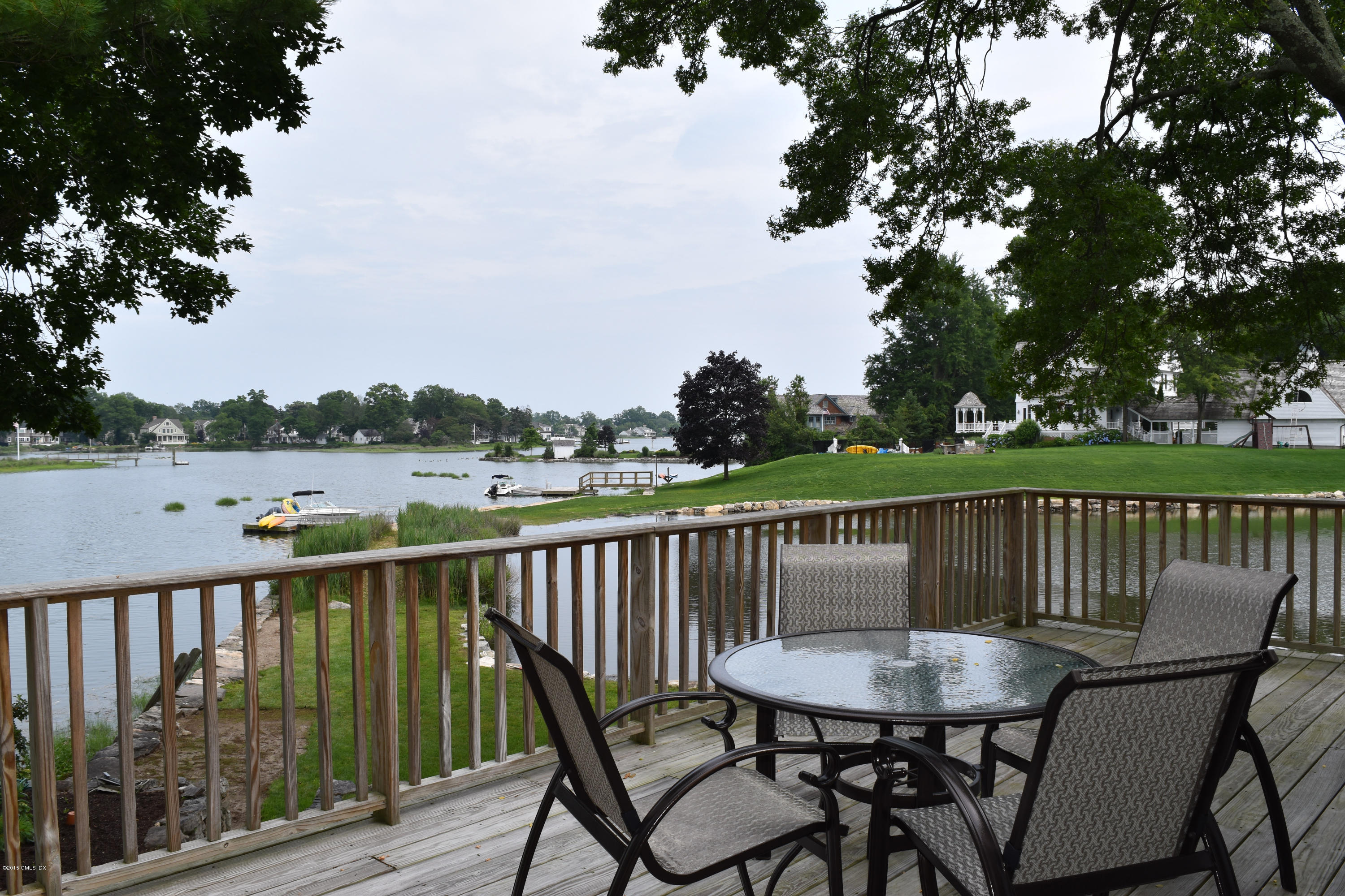 25 Willowmere Avenue Riverside, CT 06878 - Photo 6 of 12 a view of a chair and table on the deck