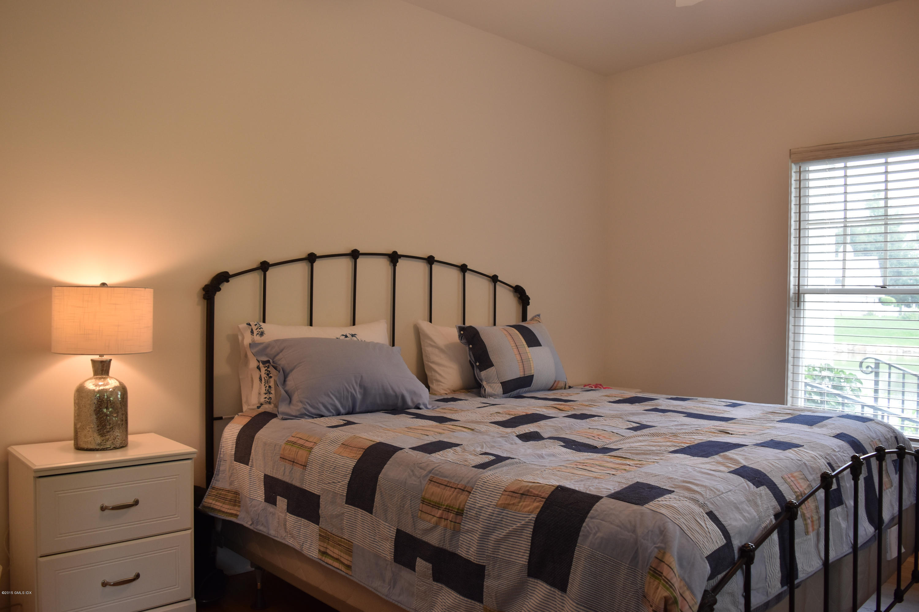 25 Willowmere Avenue Riverside, CT 06878 - Photo 8 of 12 a bedroom with a bed and a window