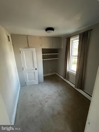 a view of empty room with a fireplace