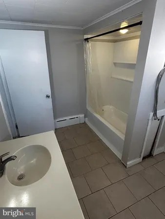 a bathroom with a tub and shower