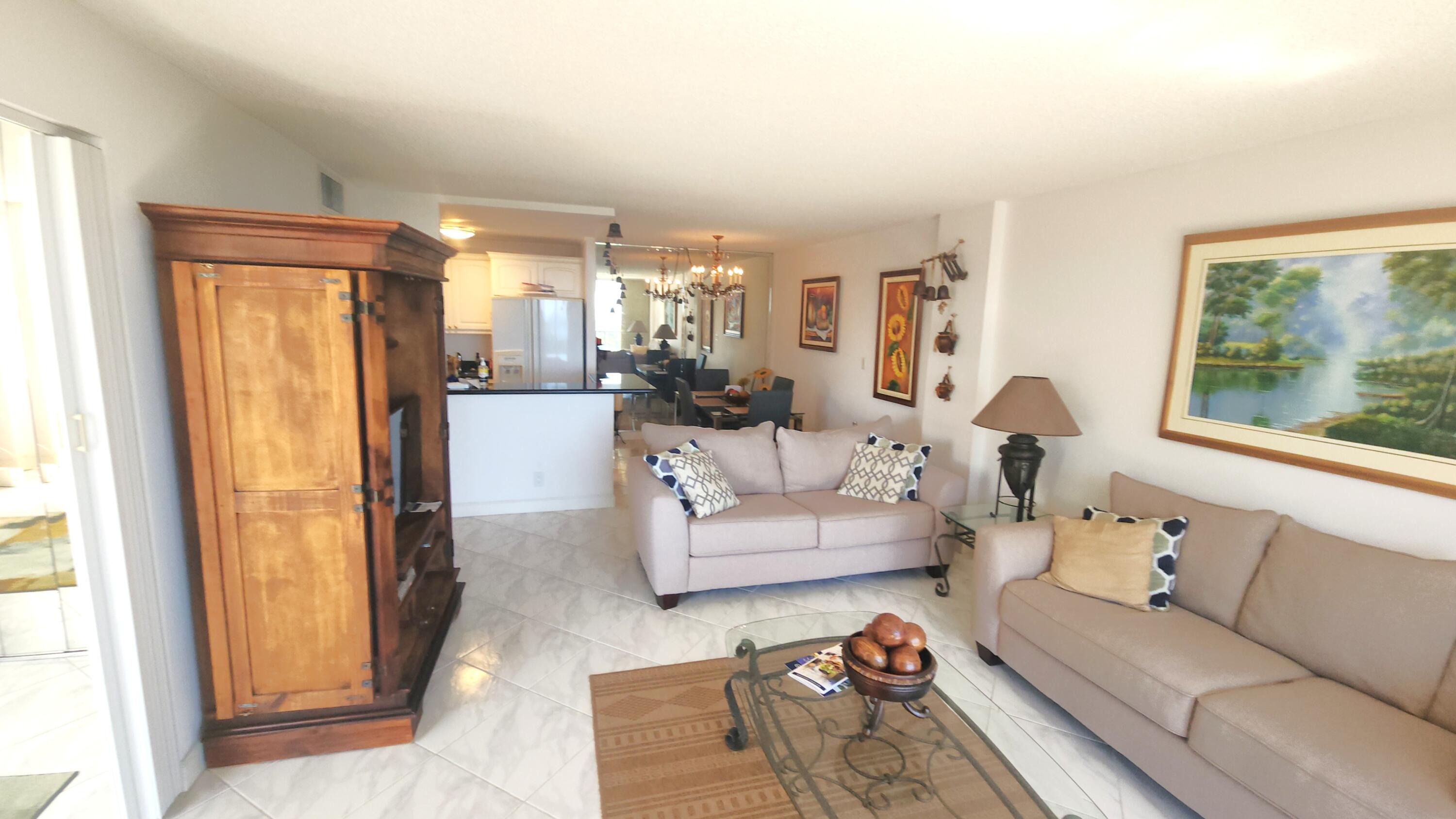 2121 North Ocean Boulevard, Unit 1205E Boca Raton, FL 33431 - Photo 14 of 54 a living room with furniture and a large window