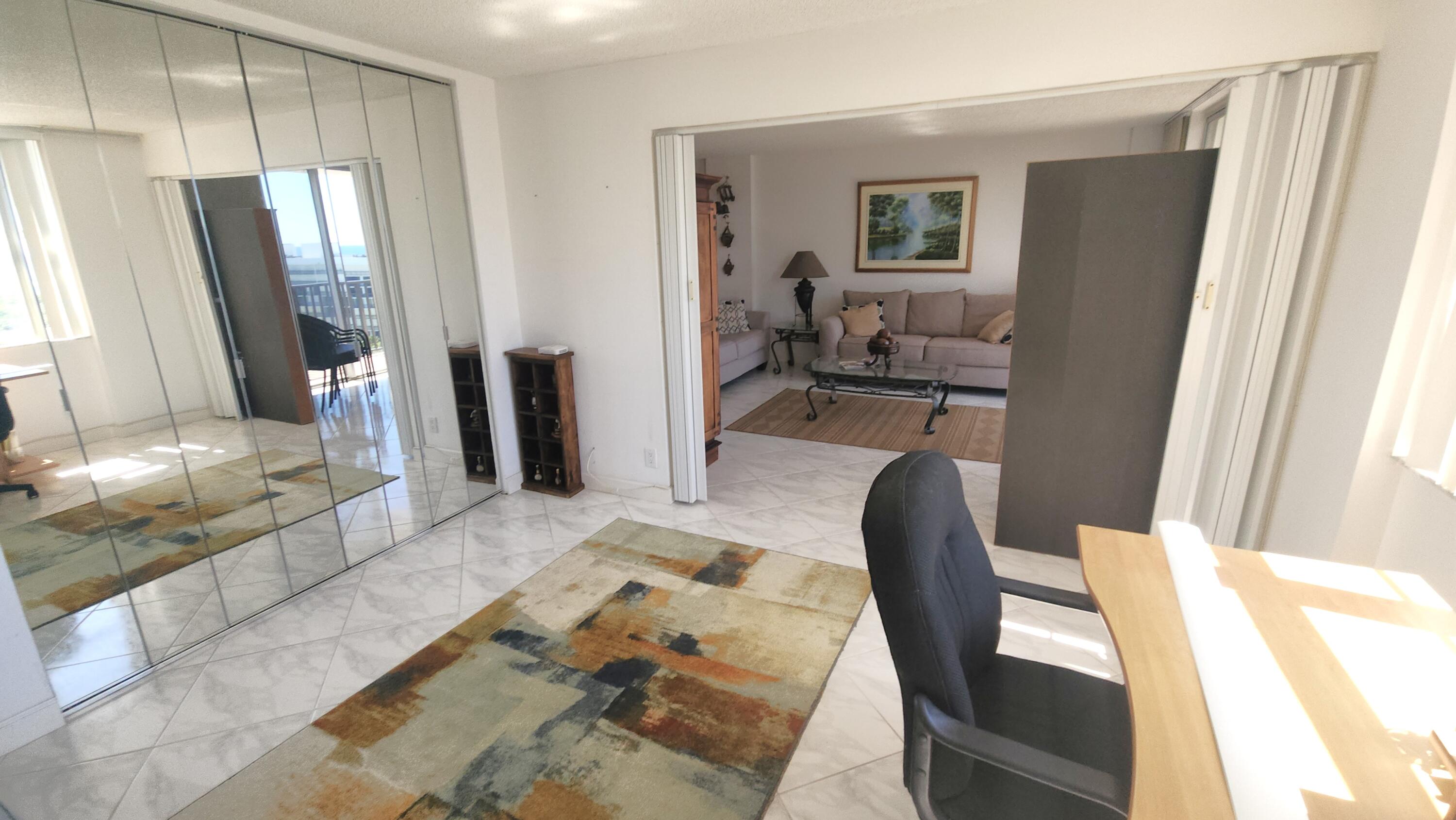 2121 North Ocean Boulevard, Unit 1205E Boca Raton, FL 33431 - Photo 21 of 54 a living room with furniture and a window