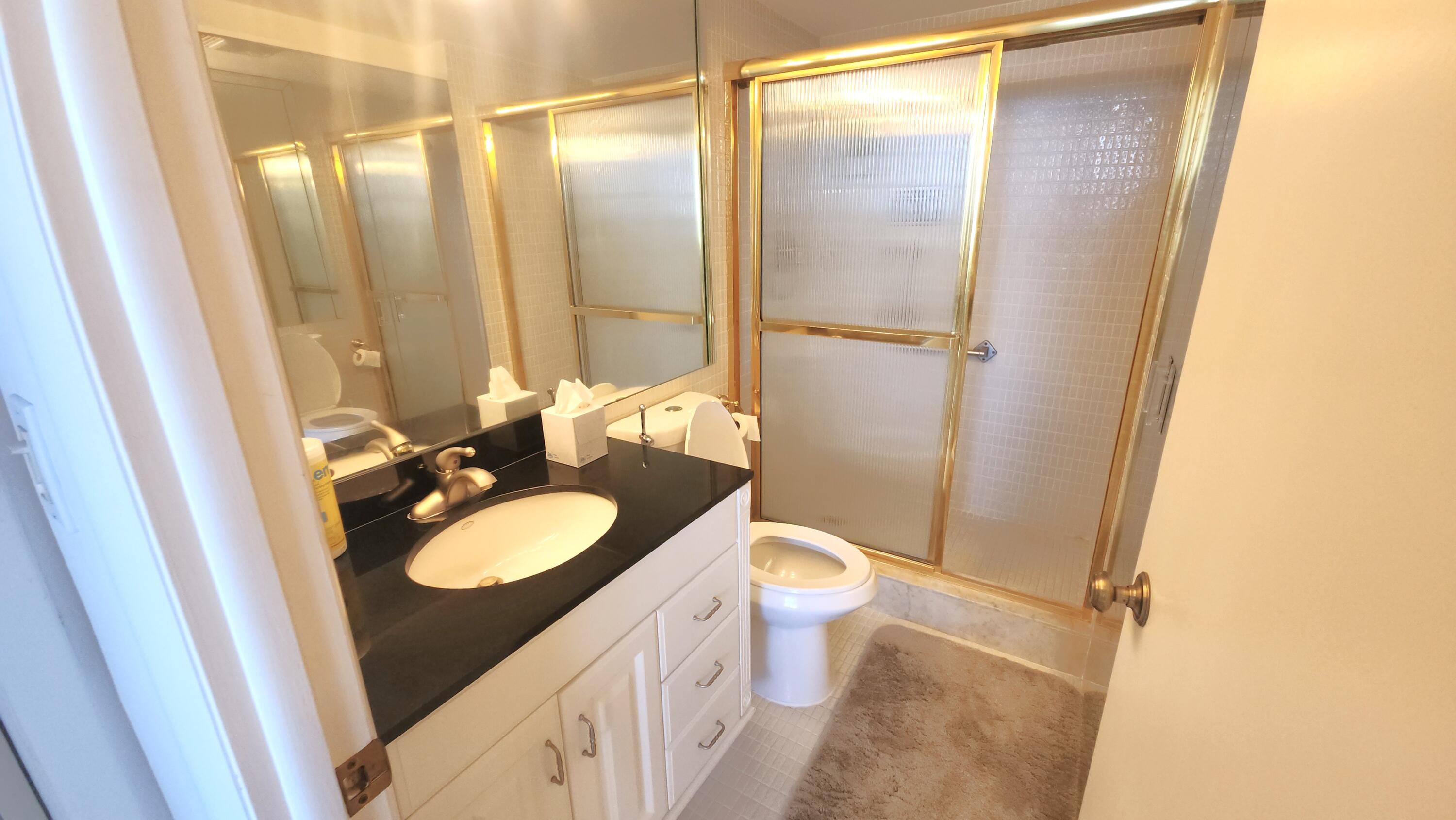 2121 North Ocean Boulevard, Unit 1205E Boca Raton, FL 33431 - Photo 23 of 54 a bathroom with a sink vanity granite and toilet