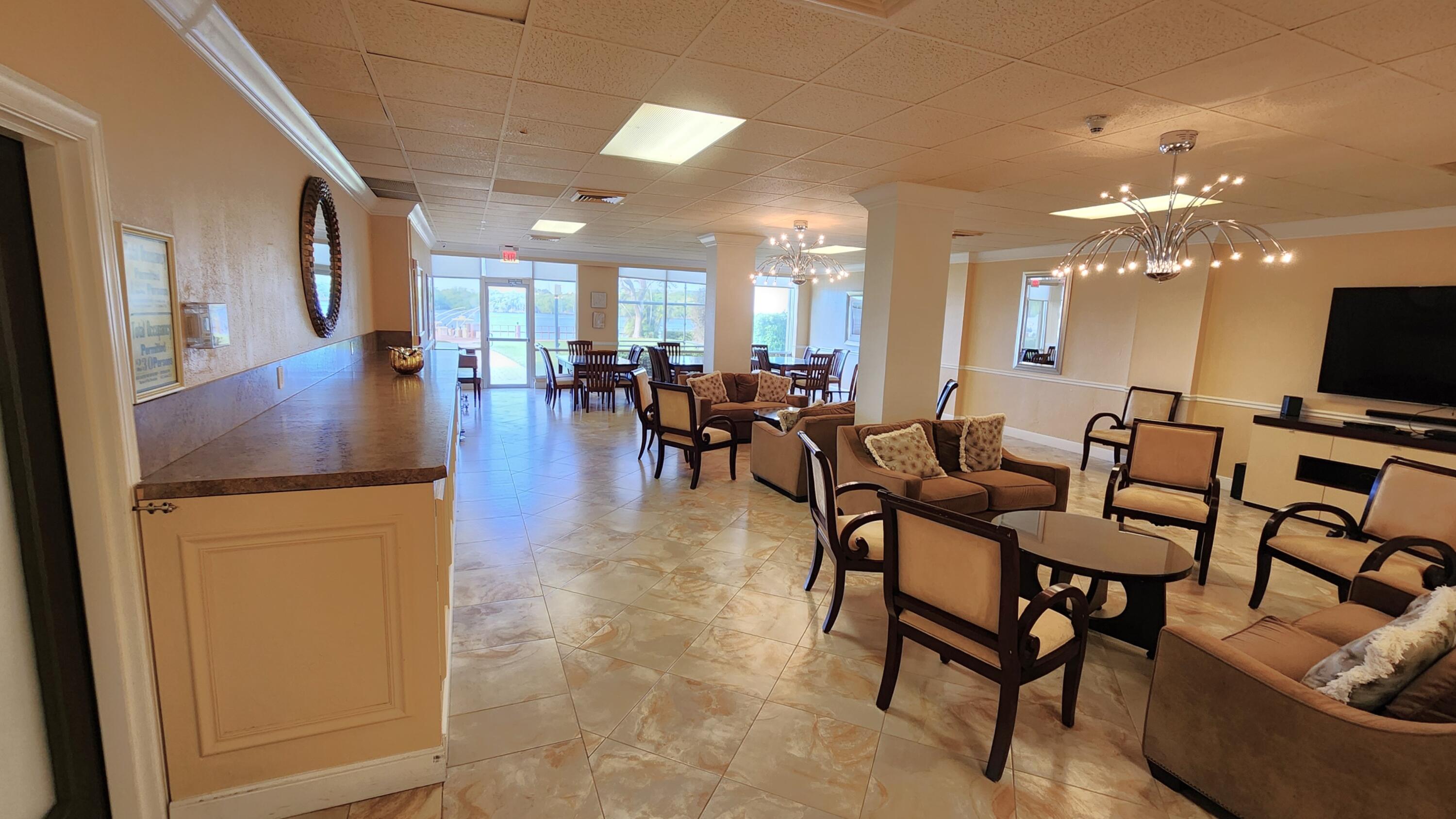 2121 North Ocean Boulevard, Unit 1205E Boca Raton, FL 33431 - Photo 33 of 54 a view of a dining room with furniture and chandelier