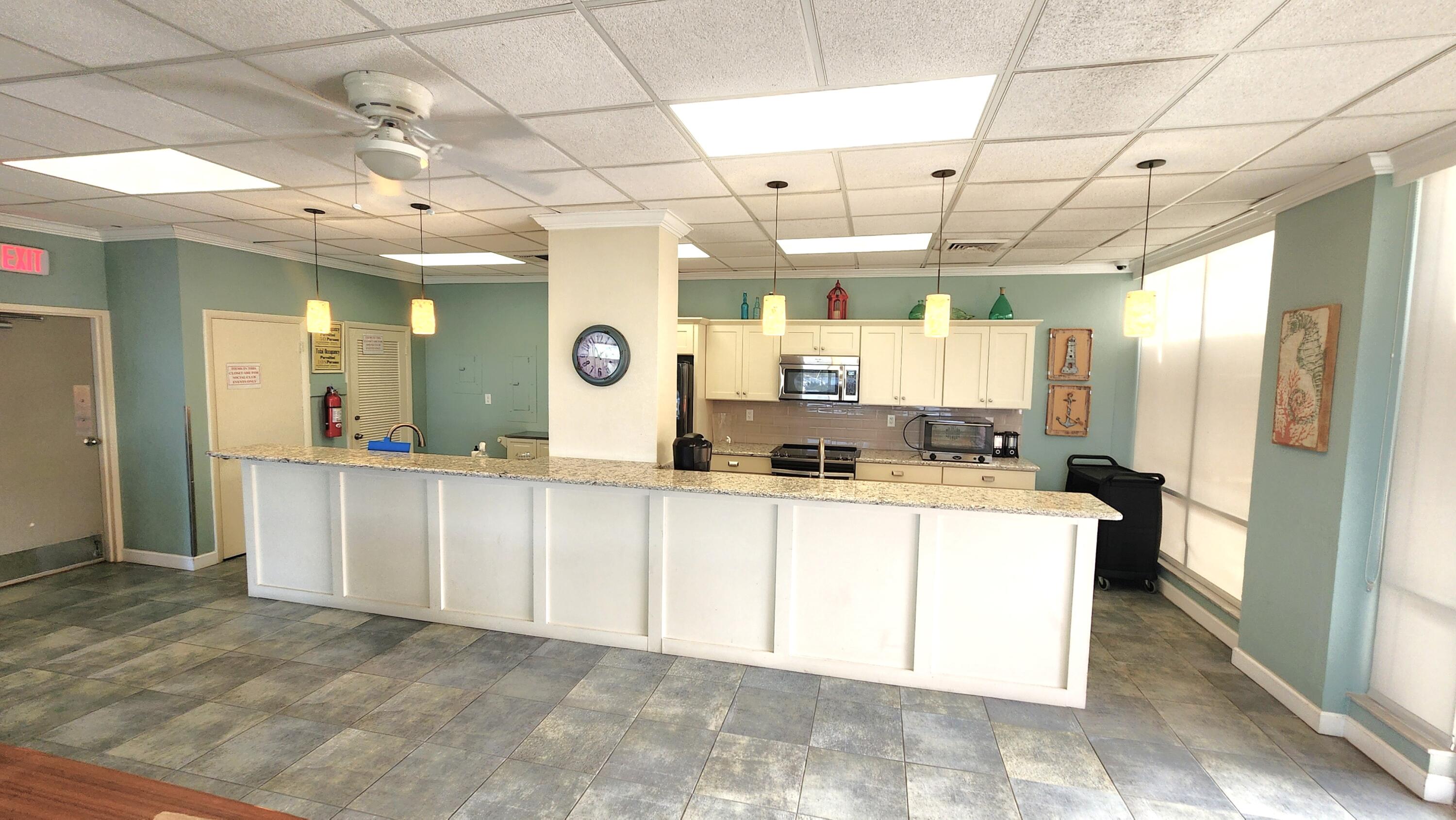 2121 North Ocean Boulevard, Unit 1205E Boca Raton, FL 33431 - Photo 37 of 54 a large white kitchen with a large window
