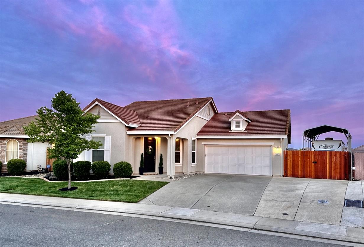 12372 Pawcatuck Way Rancho Cordova, CA 95742 - Photo 2 of 48 a front view of a house with a yard and garage