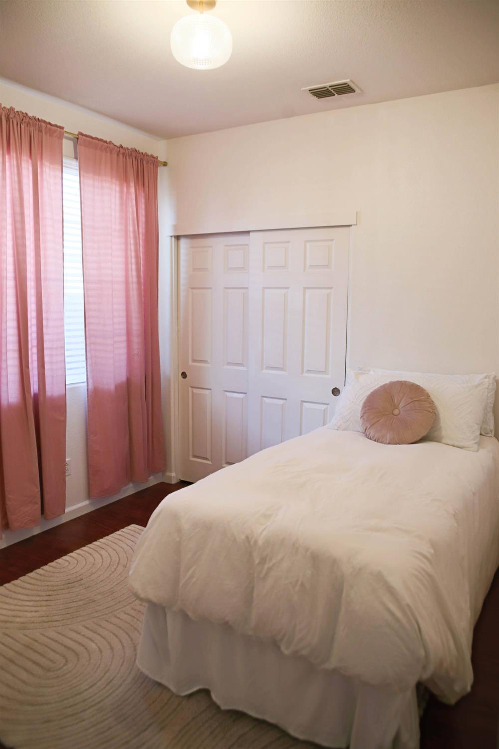 12372 Pawcatuck Way Rancho Cordova, CA 95742 - Photo 27 of 48 a large white bed in a small room