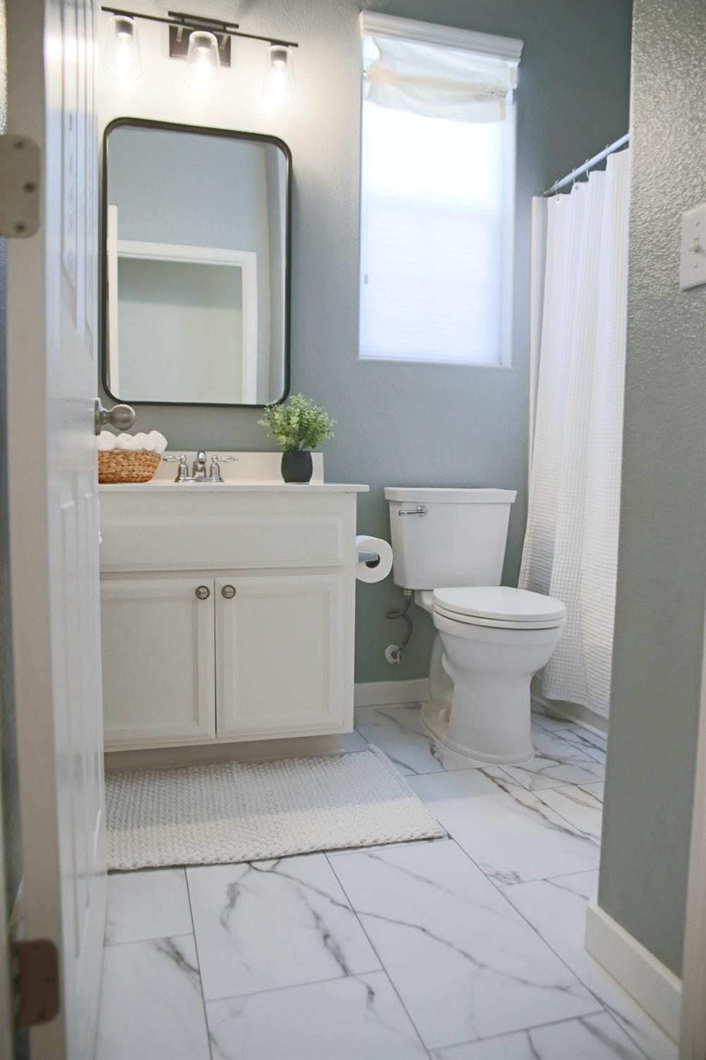 12372 Pawcatuck Way Rancho Cordova, CA 95742 - Photo 28 of 48 a bathroom with a toilet sink and mirror
