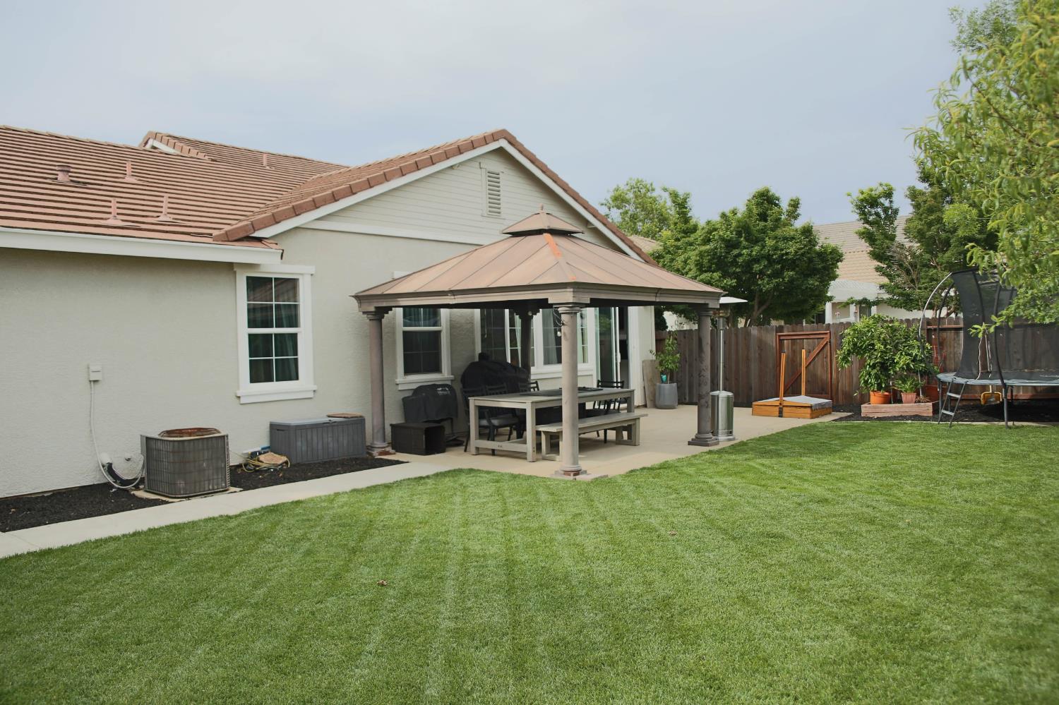 12372 Pawcatuck Way Rancho Cordova, CA 95742 - Photo 35 of 48 a backyard of a house with table and chairs