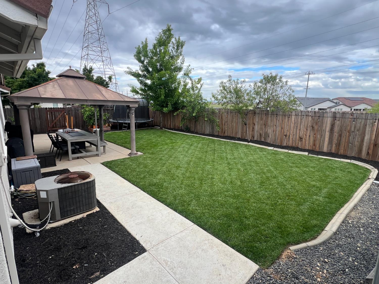 12372 Pawcatuck Way Rancho Cordova, CA 95742 - Photo 38 of 48 a view of backyard with table and chairs under an umbrella