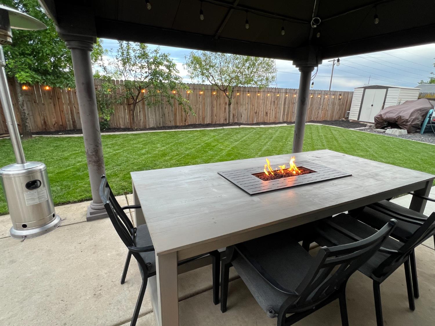 12372 Pawcatuck Way Rancho Cordova, CA 95742 - Photo 39 of 48 a view of a backyard with table and chairs under an umbrella with a small yard