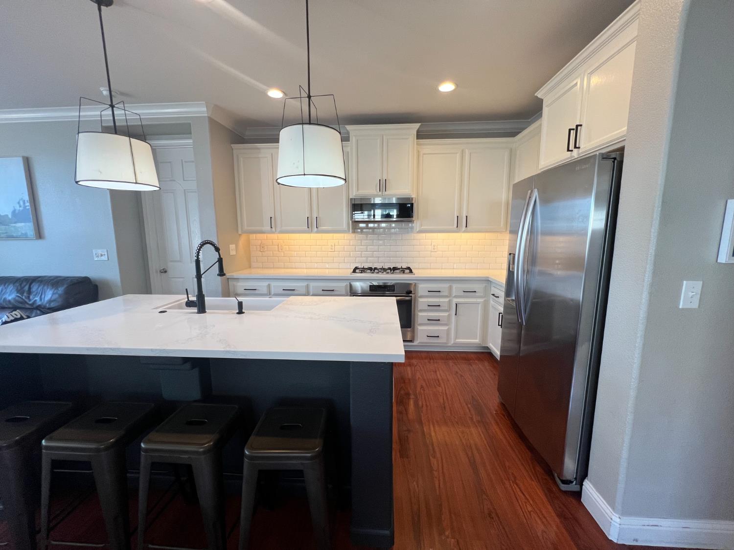12372 Pawcatuck Way Rancho Cordova, CA 95742 - Photo 8 of 48 a kitchen with refrigerator cabinets and wooden floor
