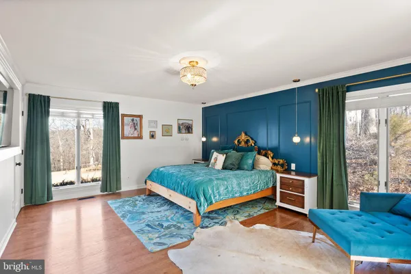 a bedroom with a bed and a chair