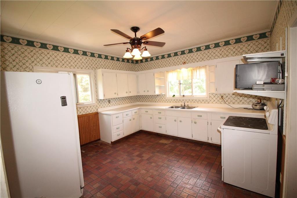 66 Gearing Road Monongahela, PA 15063 - Photo 2 of 24 Spacious 15x15 Eat-in Kitchen w/ Plenty of Wood Cabinets & Double Bowl Stainless Steel Sink. Electric Stove, Refrigerator & Ceiling Fan Light al included.Hallway included DEEP Shelved Walk-in Pantry, Full Bathroom, Linen Closet too in hallway, area for future 1st Floor Laundry & Door to Incredible Deck overlooking acreage!