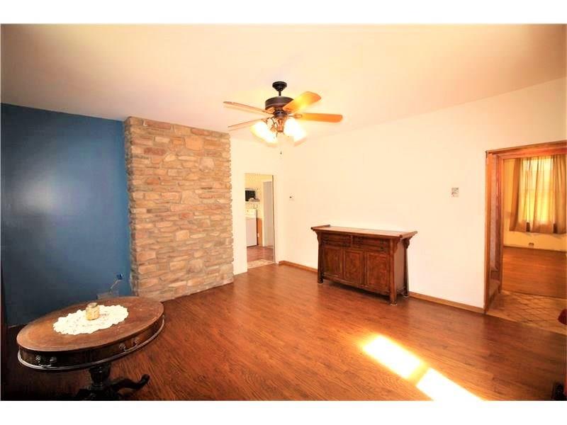 66 Gearing Road Monongahela, PA 15063 - Photo 3 of 24 Newer Flooring in Separate Formal Dining Room w/ Attractive Stone Wall & Ceiling Fan Light. Newer Drywall & extra Insualtion