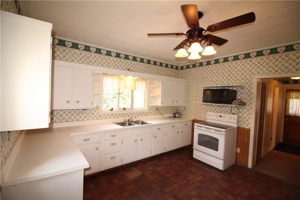 66 Gearing Road Monongahela, PA 15063 - Photo 5 of 24 Convenient Hallway off Eat-in Kitchen includes DEEP Shelved Walk-in Pantry, Full Bathroom, Linen Closet too in hallway, area for future 1st Floor Laundry & Door to Incredible Deck overlooking acreage!