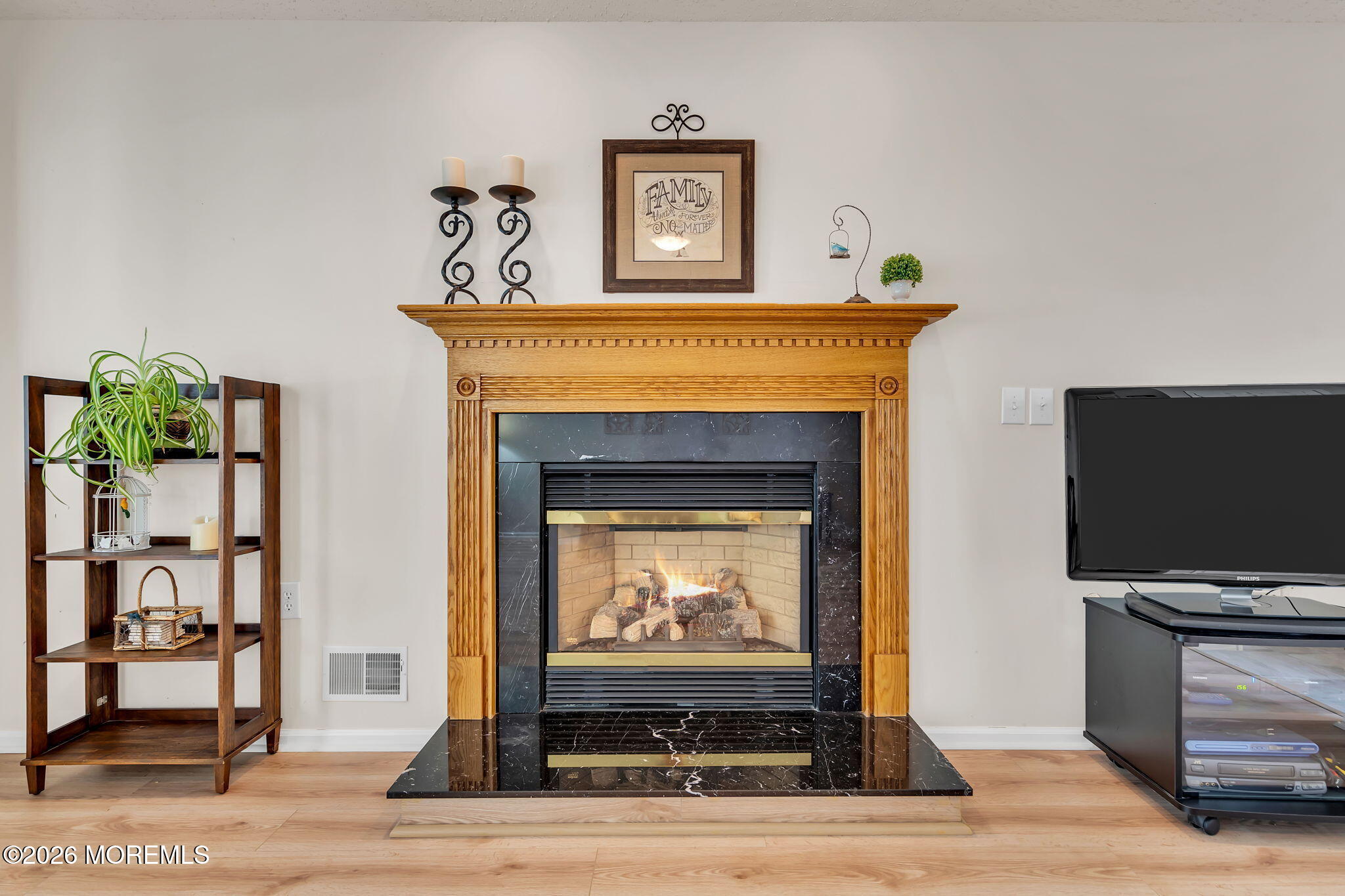 10 Congressional Road Jackson, NJ 08527 - Photo 33 of 72 a living room with a fireplace and a flat screen tv