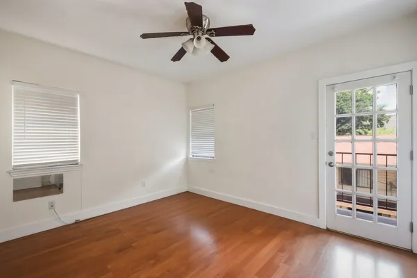 wooden floor in an empty room with a window