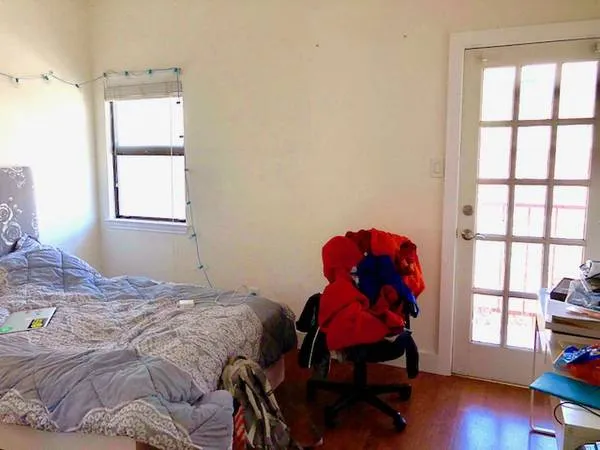 a bedroom with a bed and a window