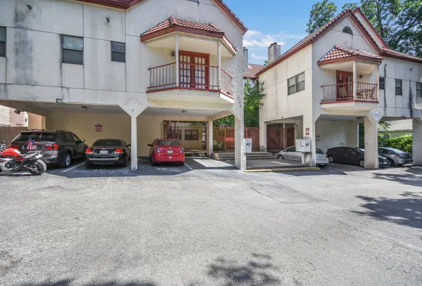 a car parked in front of white building