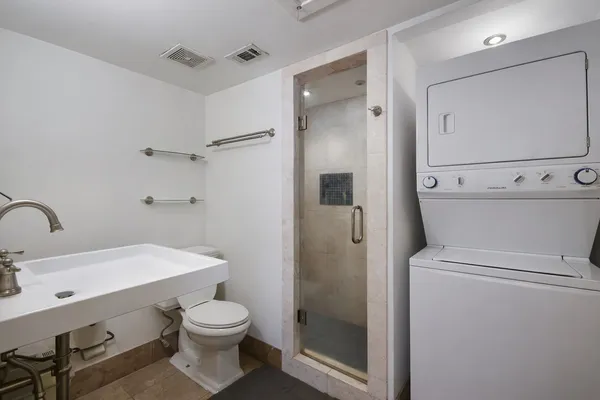 a bathroom with a sink a toilet and shower