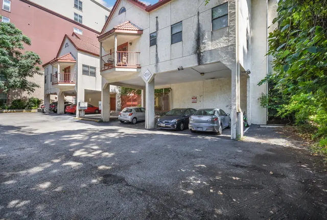 a building with car parked in front of it