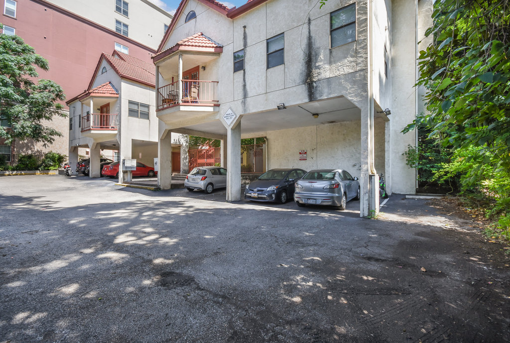 706 West 22nd Street, Unit 306 Austin, TX 78705 - Photo 6 of 19 a building with car parked in front of it