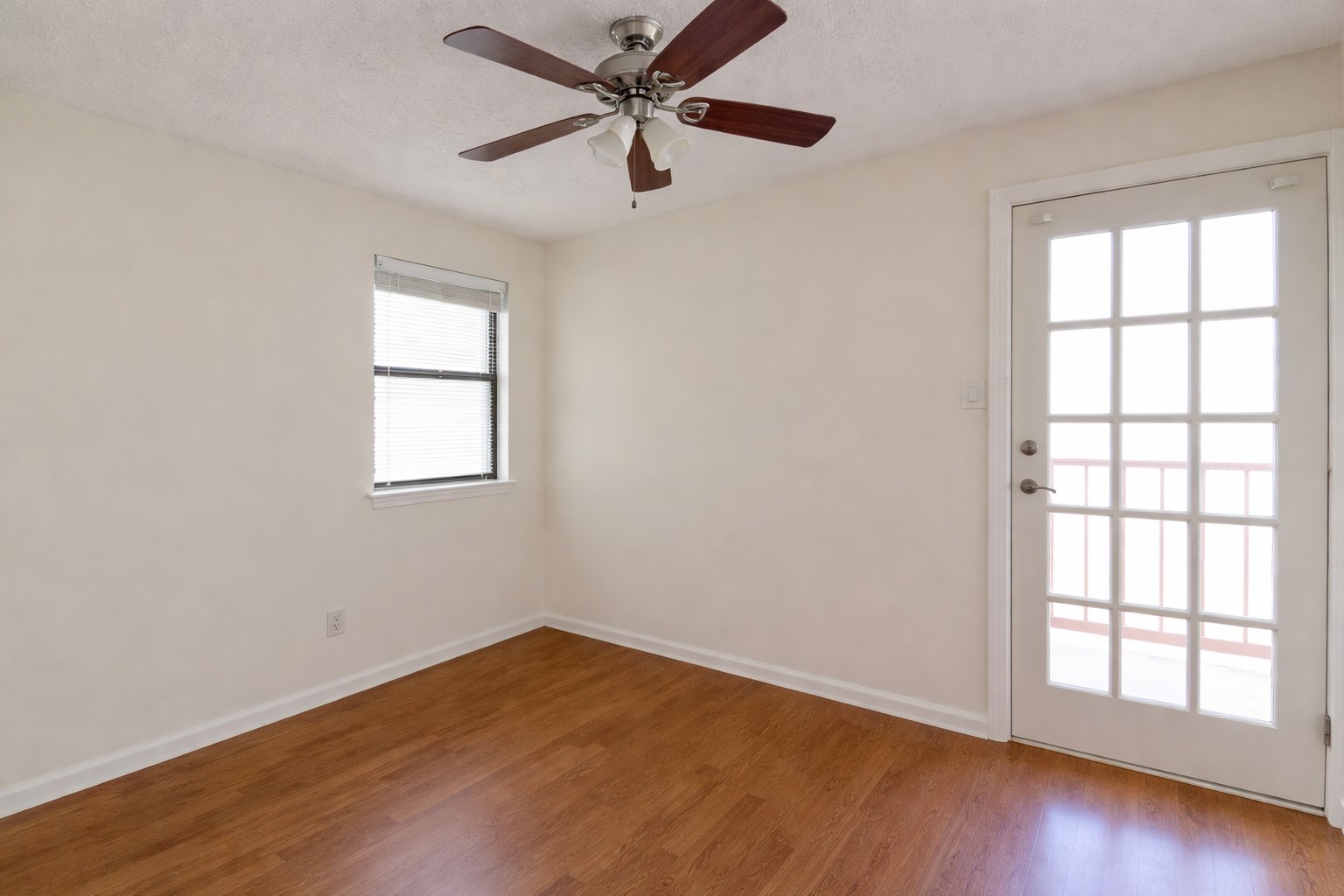 706 West 22nd Street, Unit 306 Austin, TX 78705 - Photo 9 of 19 an empty room with wooden floor windows and fan