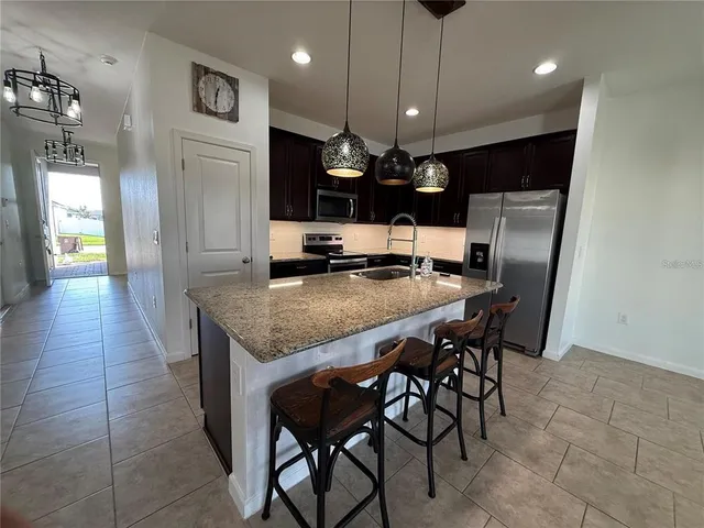 a kitchen with a table and chairs in it