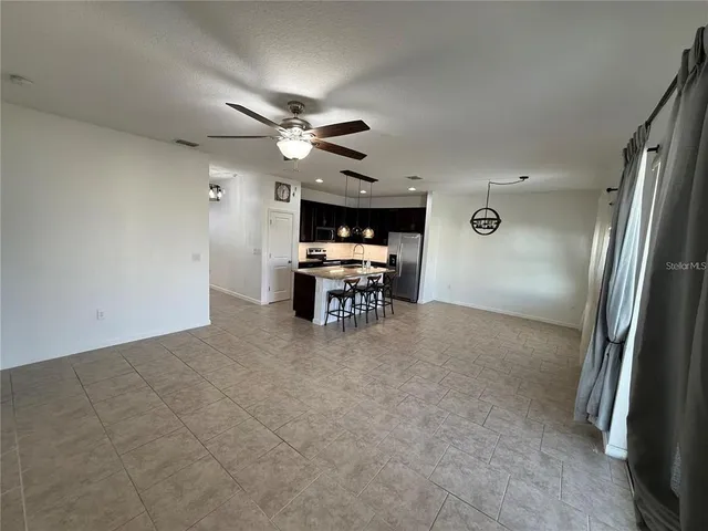 a view of livingroom with furniture and chandelier fan