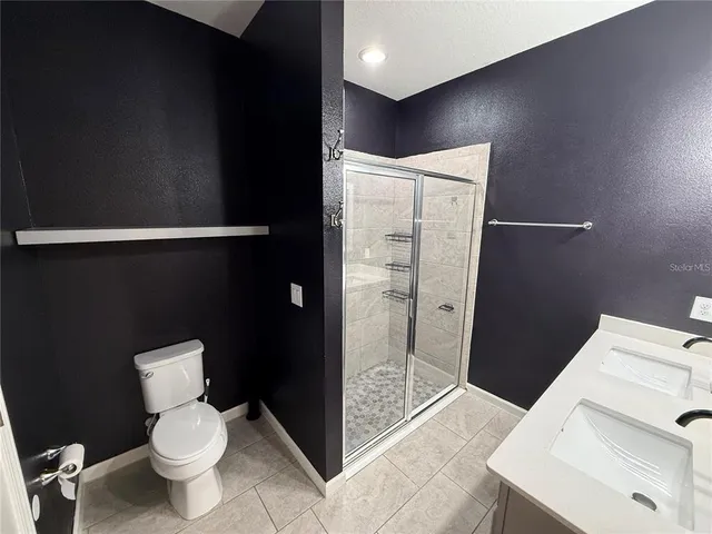 a bathroom with a toilet and a shower