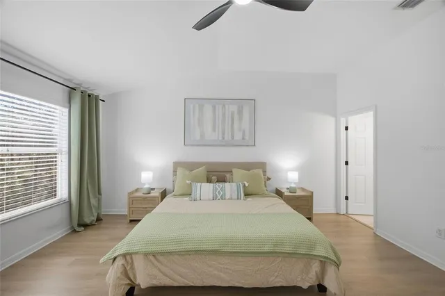 a en suite bathroom with a granite countertop sink and a mirror