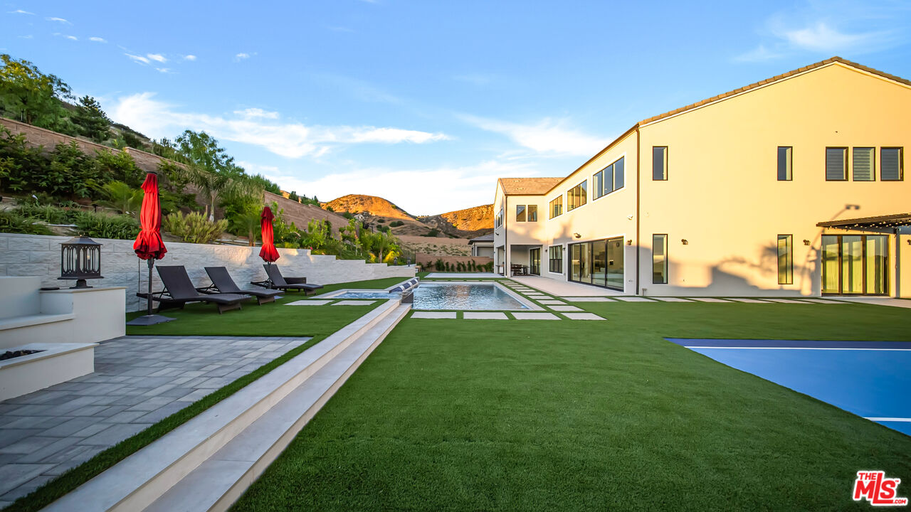 12553 Ridgeline Road Porter Ranch, CA 91326 - Photo 19 of 53 a view of an house with backyard space and porch