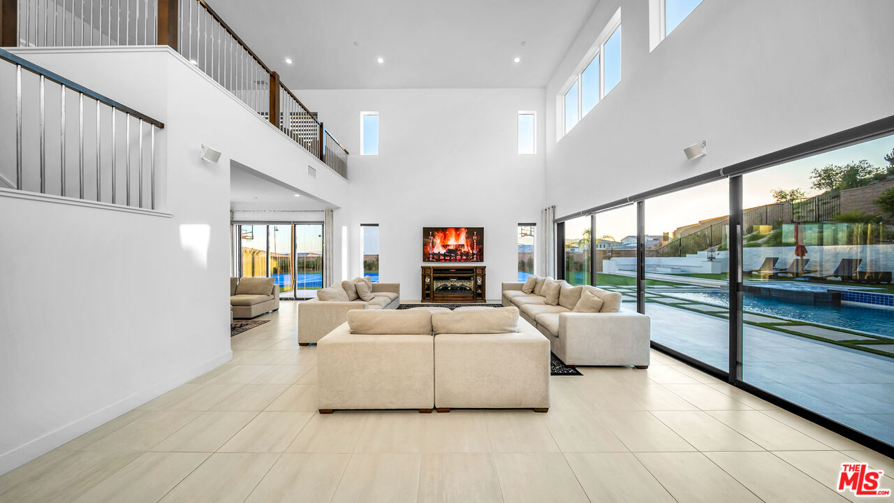 12553 Ridgeline Road Porter Ranch, CA 91326 - Photo 21 of 53 a living room with furniture and a flat screen tv