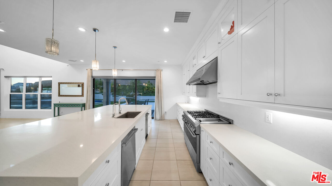 12553 Ridgeline Road Porter Ranch, CA 91326 - Photo 25 of 53 a kitchen with counter top space and stainless steel appliances