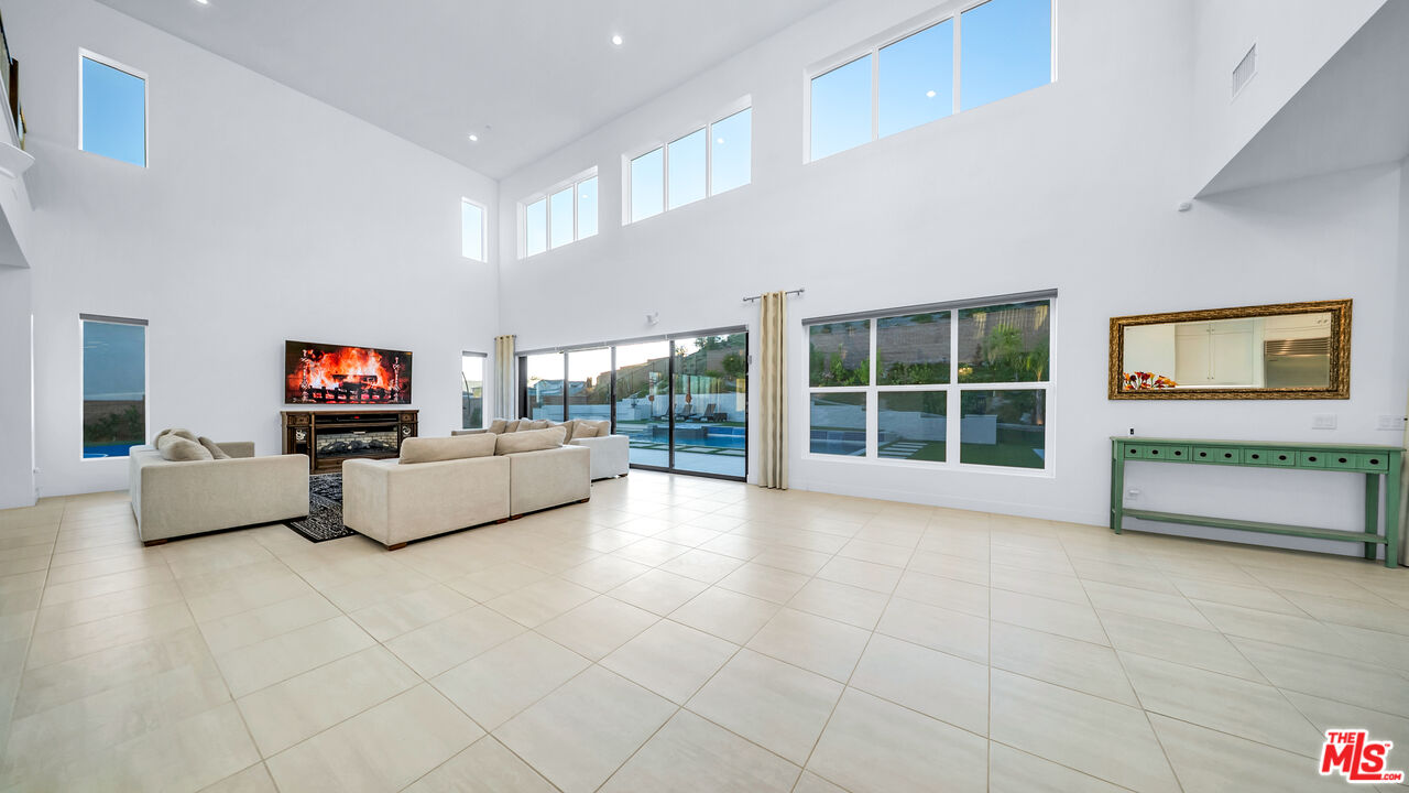 12553 Ridgeline Road Porter Ranch, CA 91326 - Photo 27 of 53 a living room with furniture and a flat screen tv