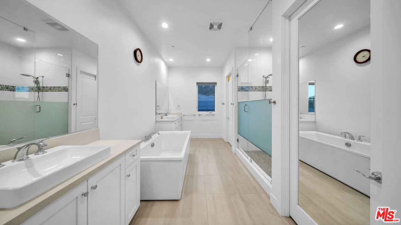 12553 Ridgeline Road Porter Ranch, CA 91326 - Photo 36 of 53 a bathroom with a sink a toilet and shower