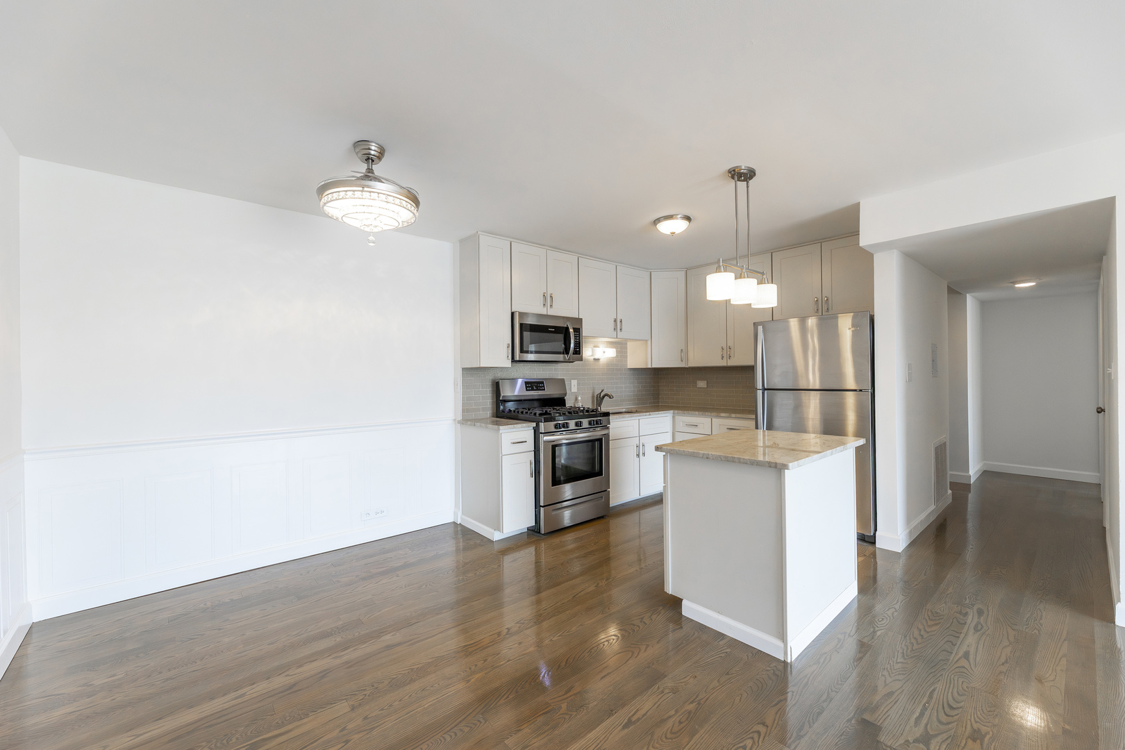 9820 South Pulaski Road, Unit 213 Oak Lawn, IL 60453 - Photo 6 of 15 a large kitchen with cabinets wooden floor and stainless steel appliances