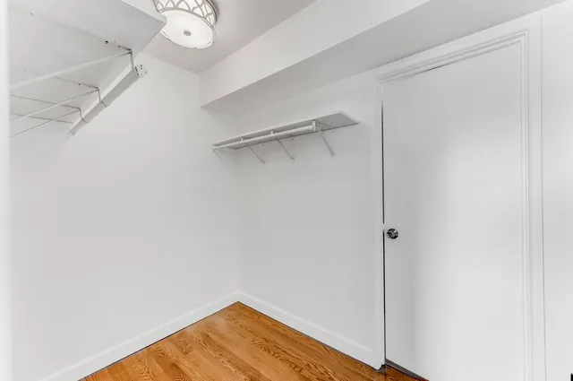 a view of a room with wooden floor