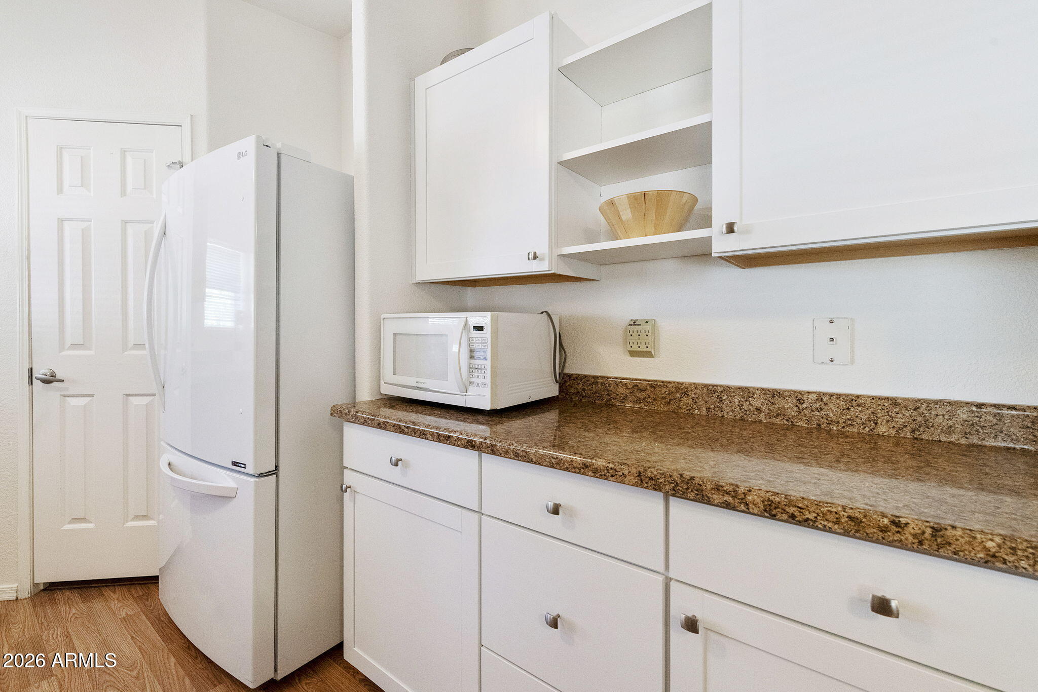 3700 South Tomahawk Road, Unit 93 Apache Junction, AZ 85119 - Photo 13 of 32 a kitchen with appliances and cabinets