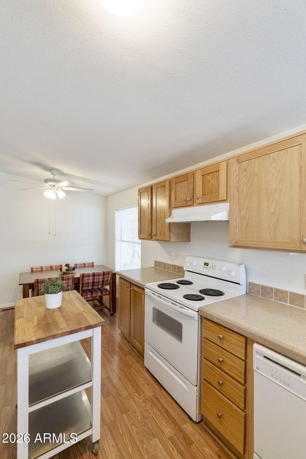 3700 South Tomahawk Road, Unit 93 Apache Junction, AZ 85119 - Photo 15 of 32 a kitchen with granite countertop a sink a stove and cabinets