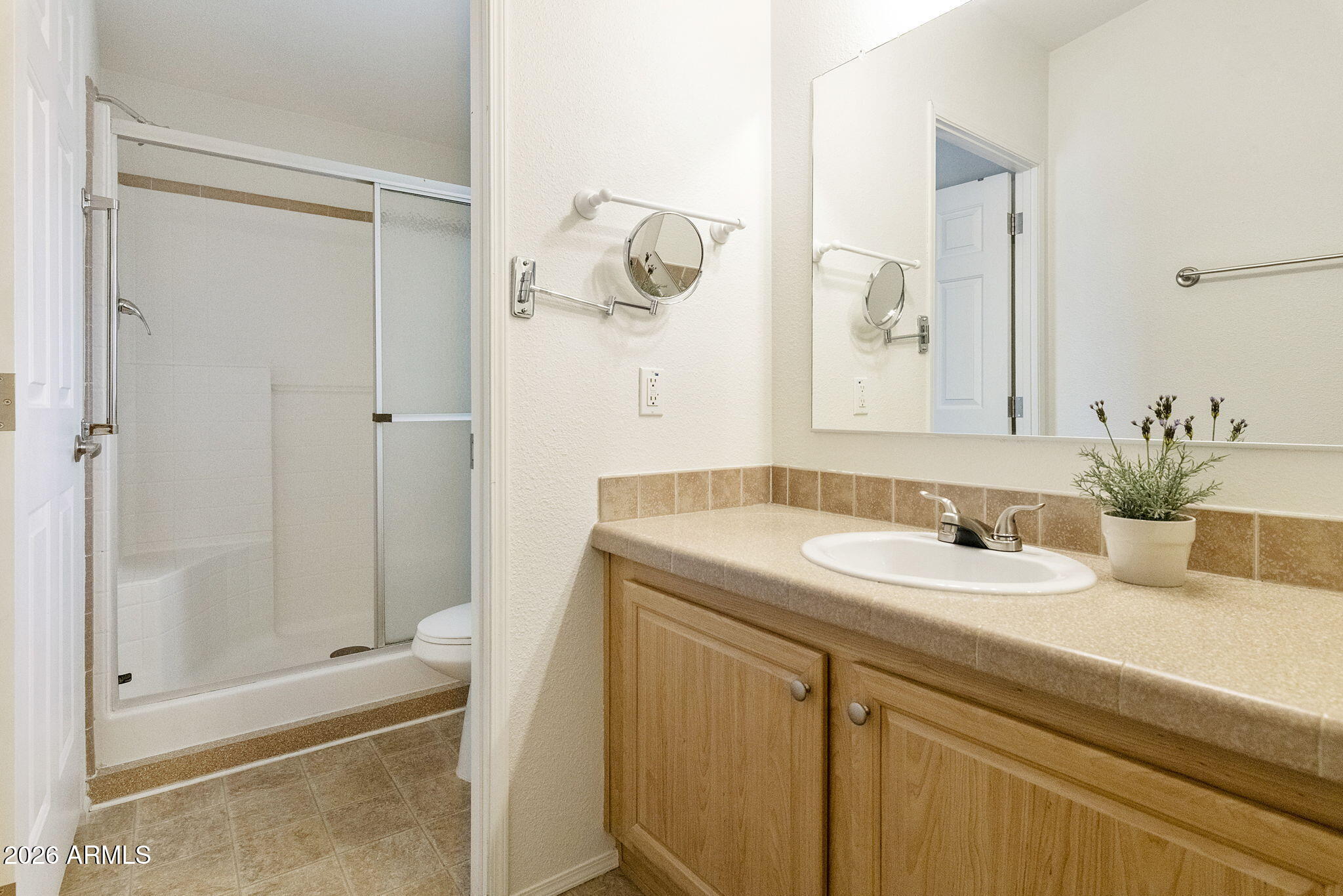 3700 South Tomahawk Road, Unit 93 Apache Junction, AZ 85119 - Photo 19 of 32 a bathroom with a granite countertop sink a toilet and shower