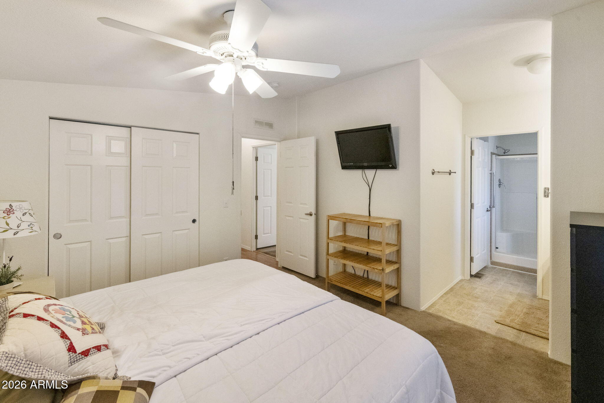 3700 South Tomahawk Road, Unit 93 Apache Junction, AZ 85119 - Photo 21 of 32 a bedroom with a bed and a flat screen tv