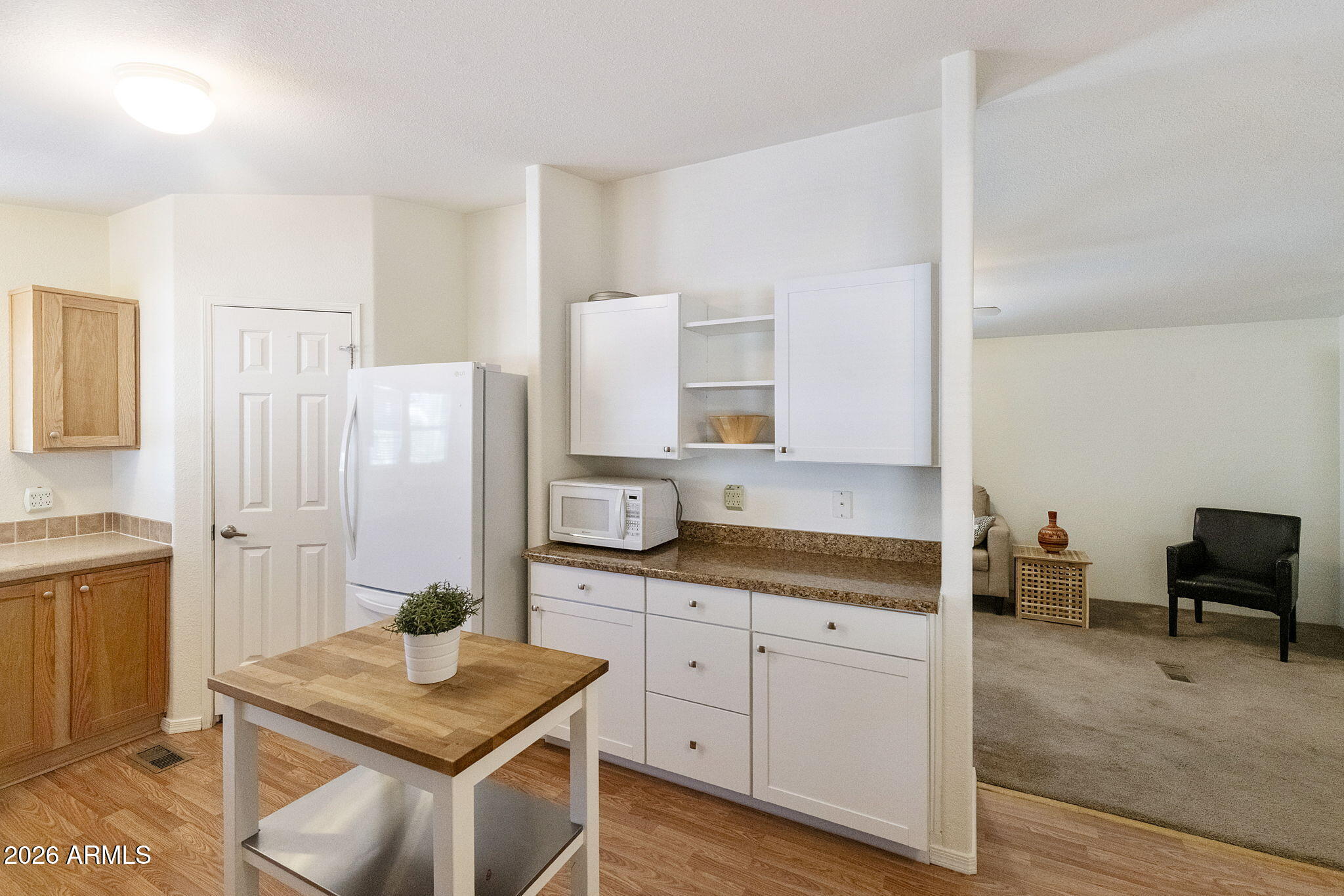 3700 South Tomahawk Road, Unit 93 Apache Junction, AZ 85119 - Photo 23 of 32 a kitchen with stainless steel appliances granite countertop a sink and a refrigerator