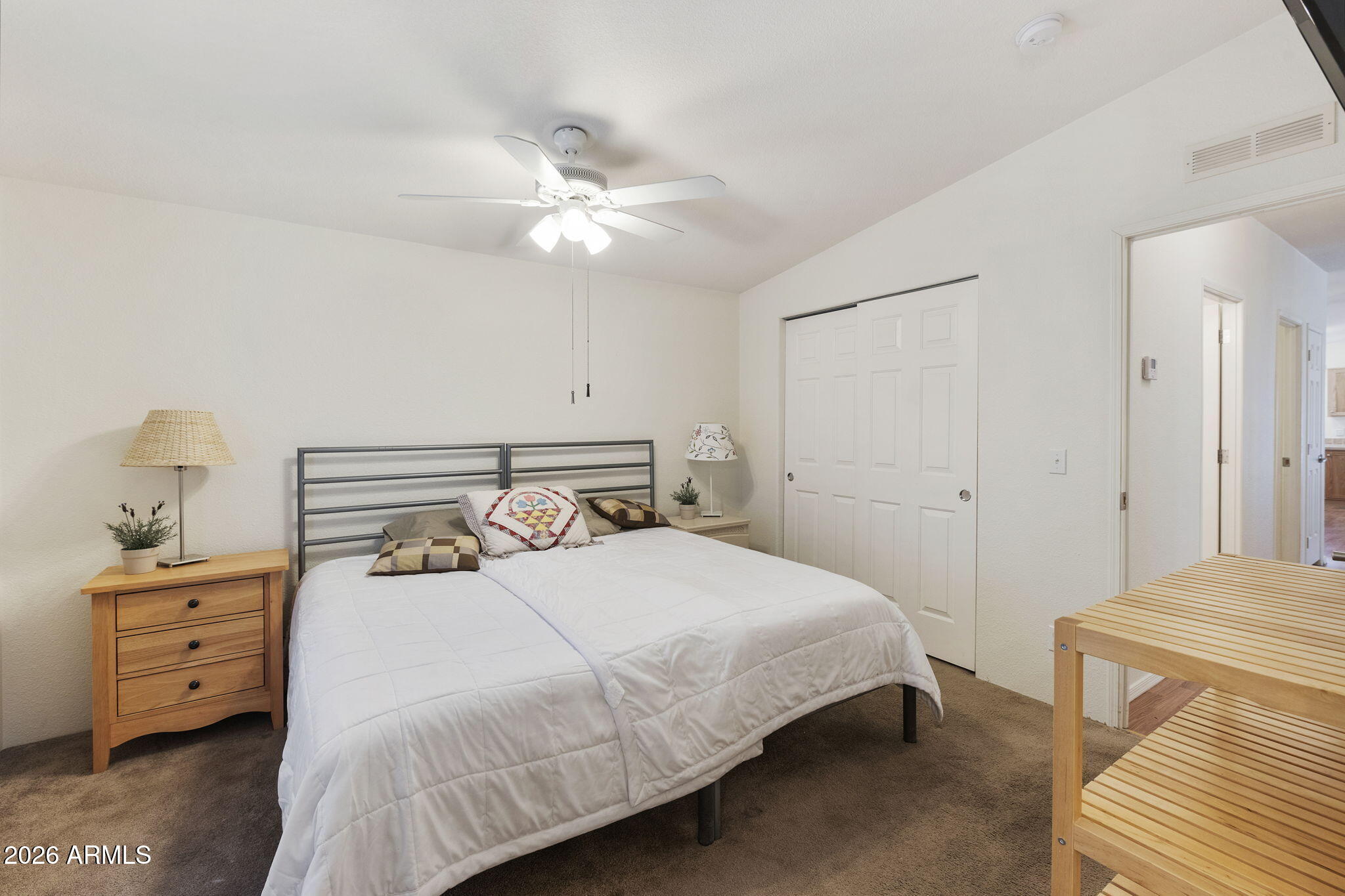 3700 South Tomahawk Road, Unit 93 Apache Junction, AZ 85119 - Photo 25 of 32 a bedroom with a bed and a chandelier