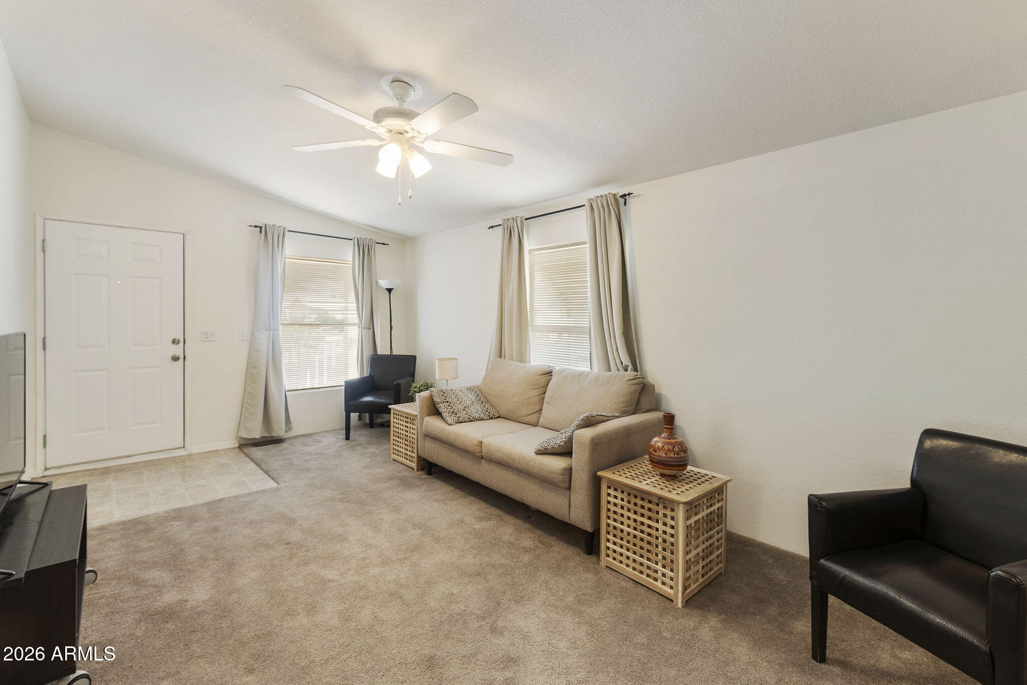 3700 South Tomahawk Road, Unit 93 Apache Junction, AZ 85119 - Photo 27 of 32 a living room with furniture and a chandelier