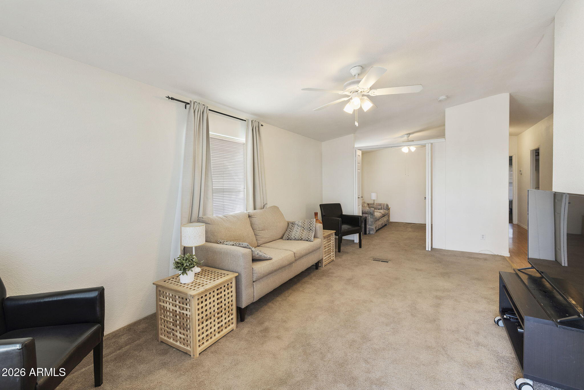 3700 South Tomahawk Road, Unit 93 Apache Junction, AZ 85119 - Photo 32 of 32 a living room with furniture and a flat screen tv