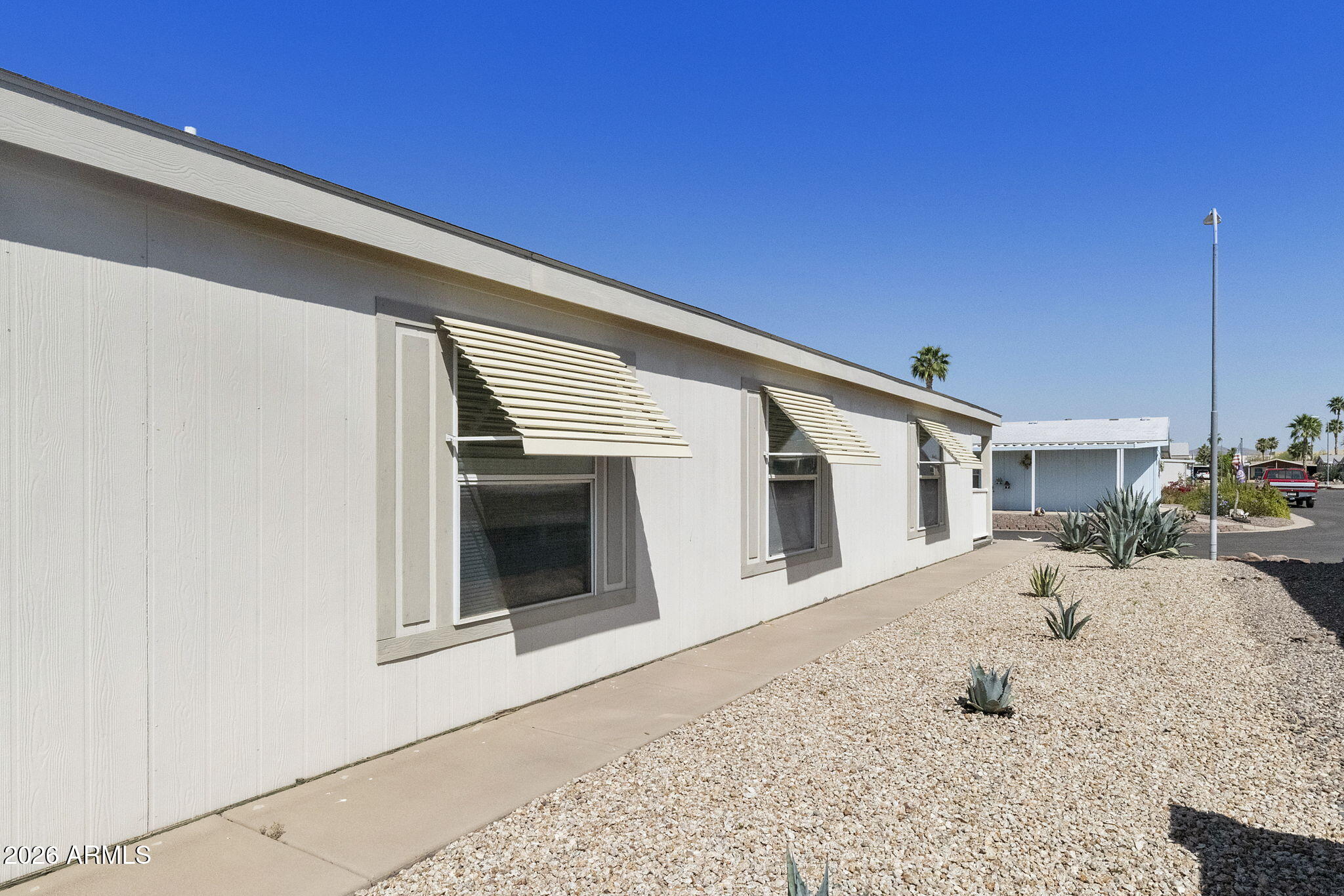 3700 South Tomahawk Road, Unit 93 Apache Junction, AZ 85119 - Photo 5 of 32 a view of a house with a patio