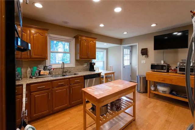 a kitchen with a sink appliances and cabinets
